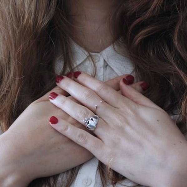 A person resting both hands over their heart
